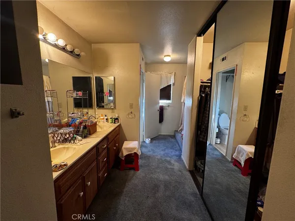 a kitchen with stainless steel appliances a table chairs and refrigerator