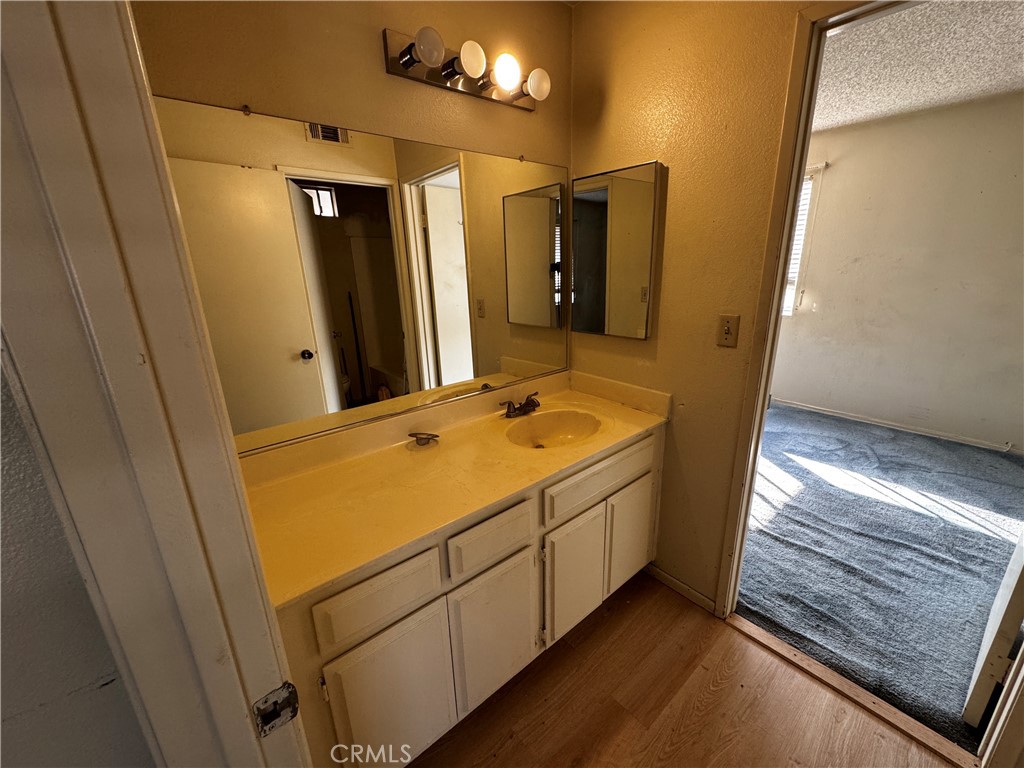 935 West Wabash Street Rialto, CA 92376 - Photo 14 of 17 a bathroom with a sink and a mirror