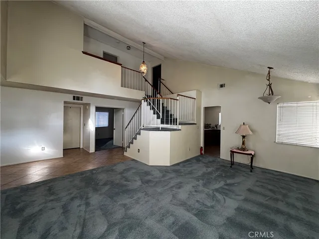 a view of a livingroom with furniture and staircase