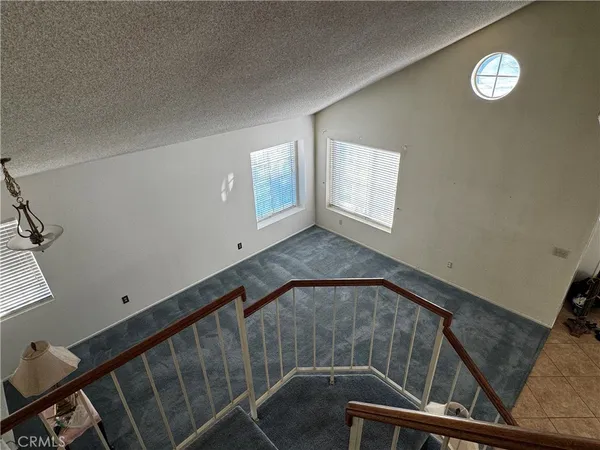 a view of an empty room with windows