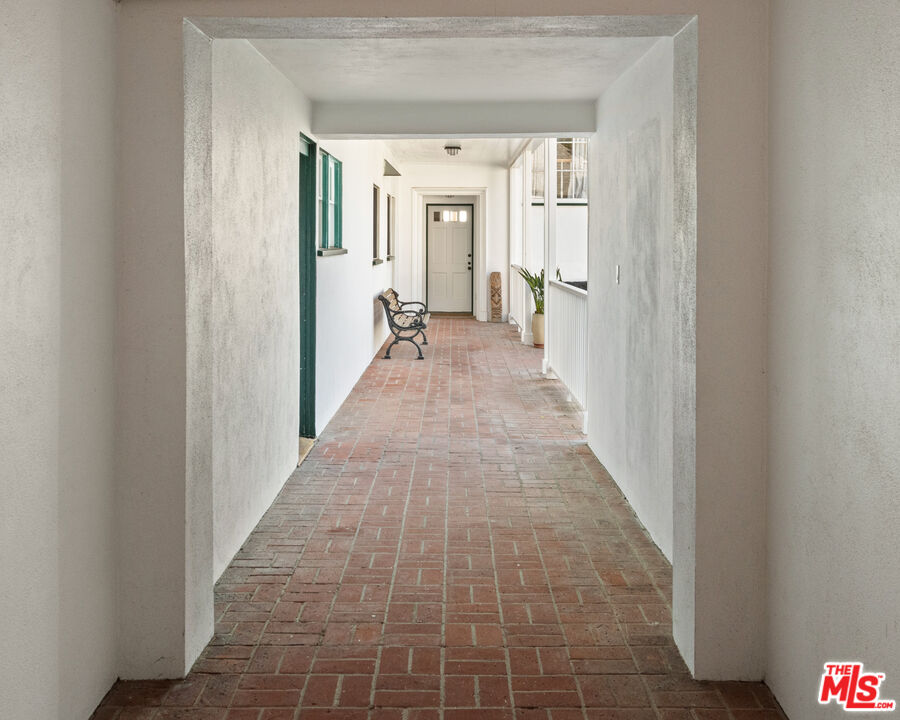 605 Palisades Beach Road Santa Monica, CA 90402 - Photo 9 of 33 a view of a hallway with white walls and stairs