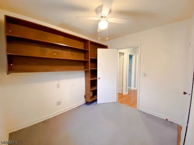 a view of an empty room with a ceiling fan