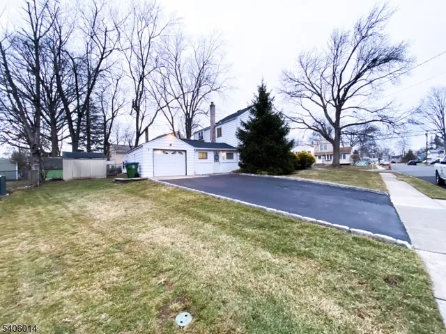 a view of a yard with a house and large trees