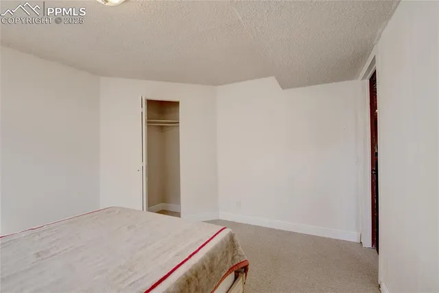 a bedroom with a bed and a cabinet