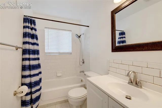 a bathroom with a sink a toilet a mirror and shower