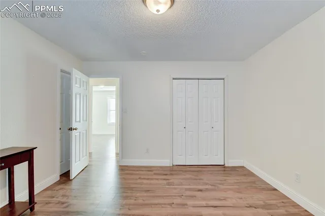a view of an empty room and wooden floor
