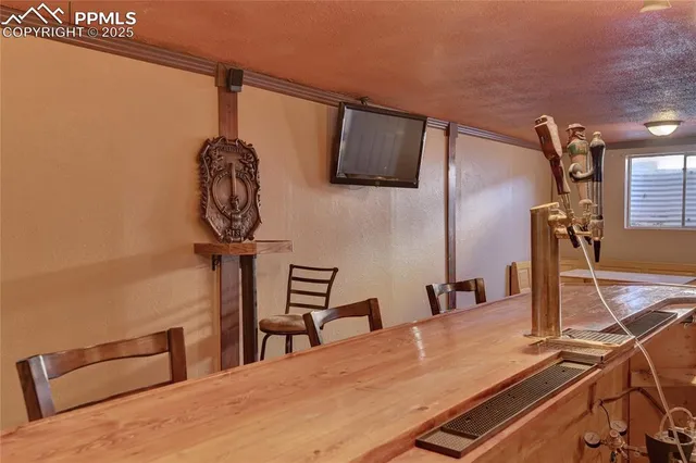 a view of a dining room with furniture and window