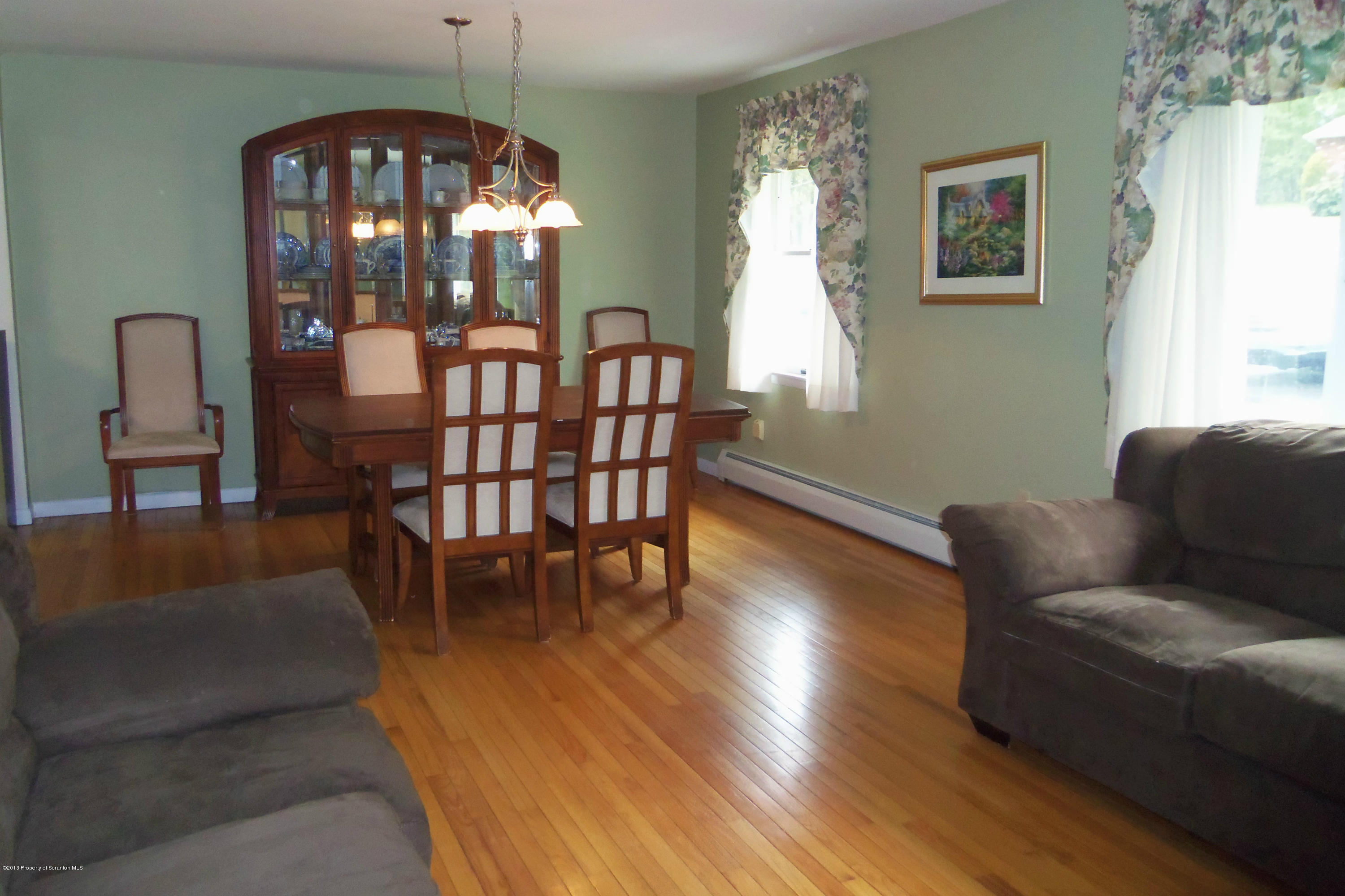 930 Griffin Road Moscow, PA 18444 - Photo 3 of 39 a dining room with furniture a chandelier and wooden floor