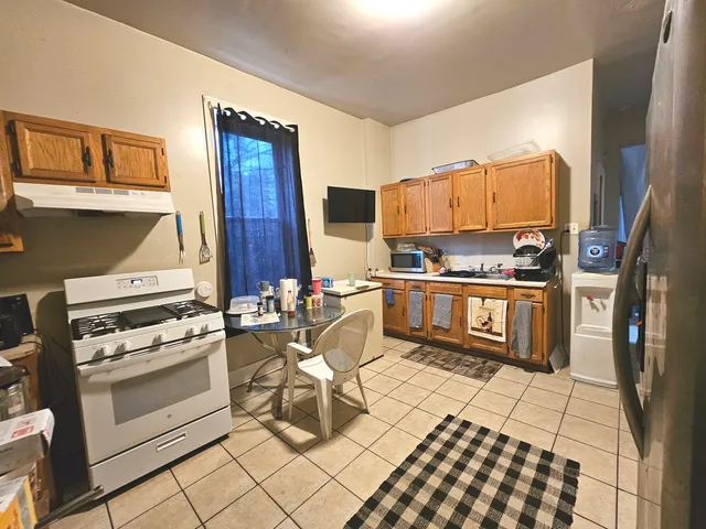 a kitchen with a stove a sink and a microwave