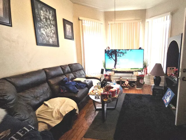 a living room with furniture fireplace and a large window