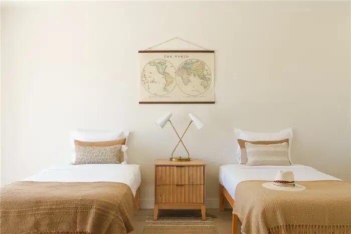 4622 Avenida La Mirada Joshua Tree, CA 92252 - Photo 11 of 22 a bedroom with a bed and a wall painting