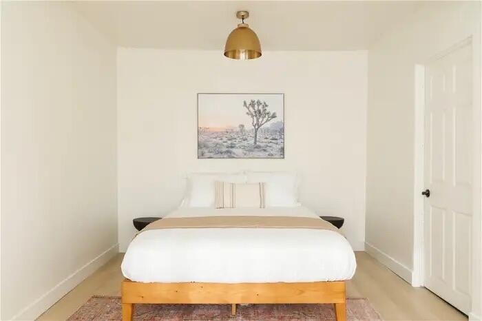 4622 Avenida La Mirada Joshua Tree, CA 92252 - Photo 19 of 22 a bed sitting in a bedroom next to a bathroom