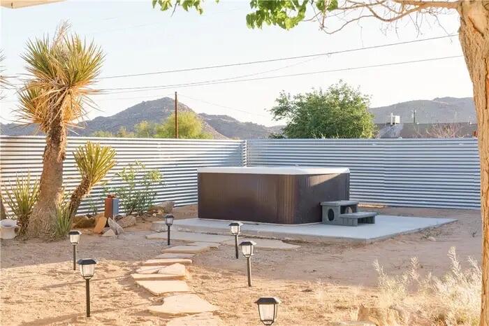 4622 Avenida La Mirada Joshua Tree, CA 92252 - Photo 20 of 22 a backyard of a house with table and chairs