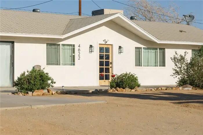 4622 Avenida La Mirada Joshua Tree, CA 92252 - Photo 3 of 22 a front view of a house with a road