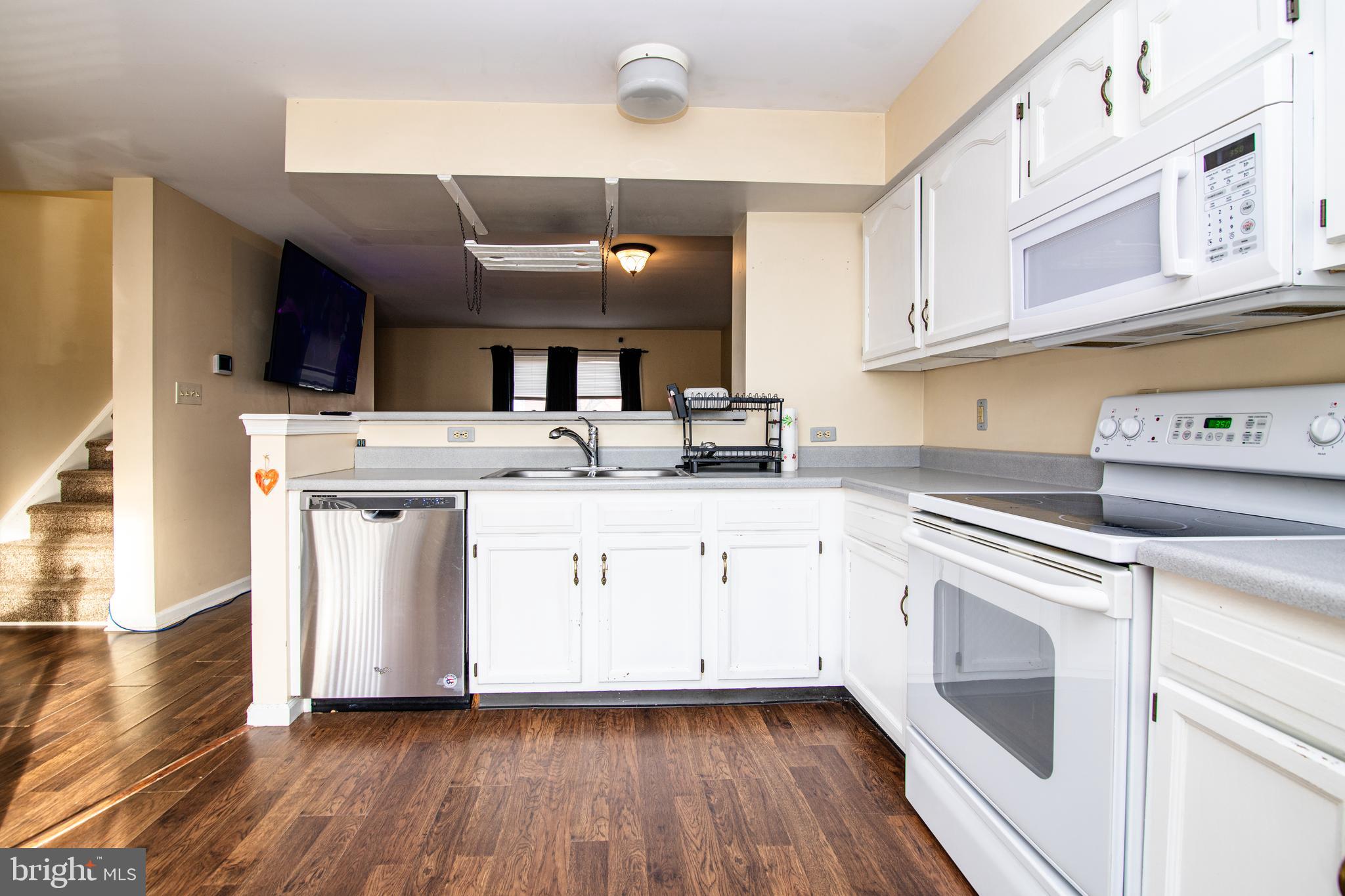 26 Thyme Street Elkton, MD 21921 - Photo 4 of 10 a kitchen with a stove a sink and a refrigerator