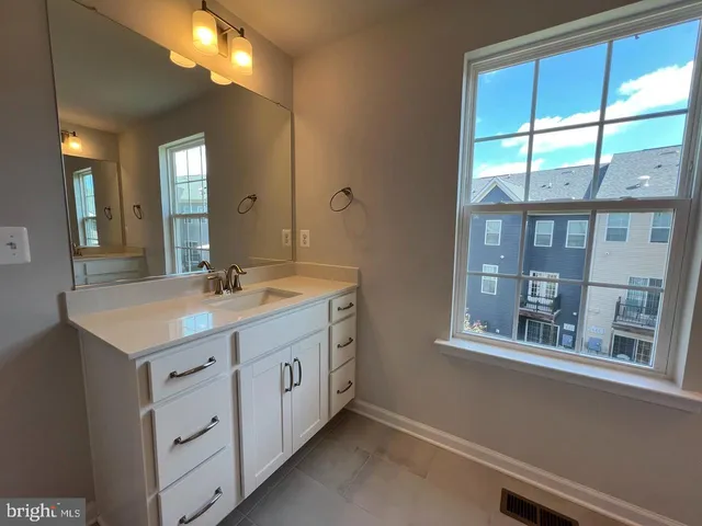 a bathroom with a double vanity sink and a mirror