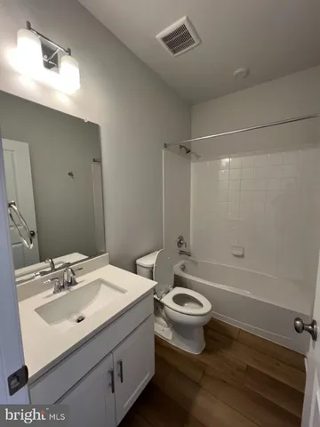 a bathroom with a sink toilet a mirror and shower