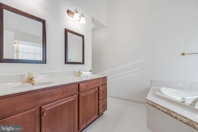 a spacious bathroom with a bathtub and a shower