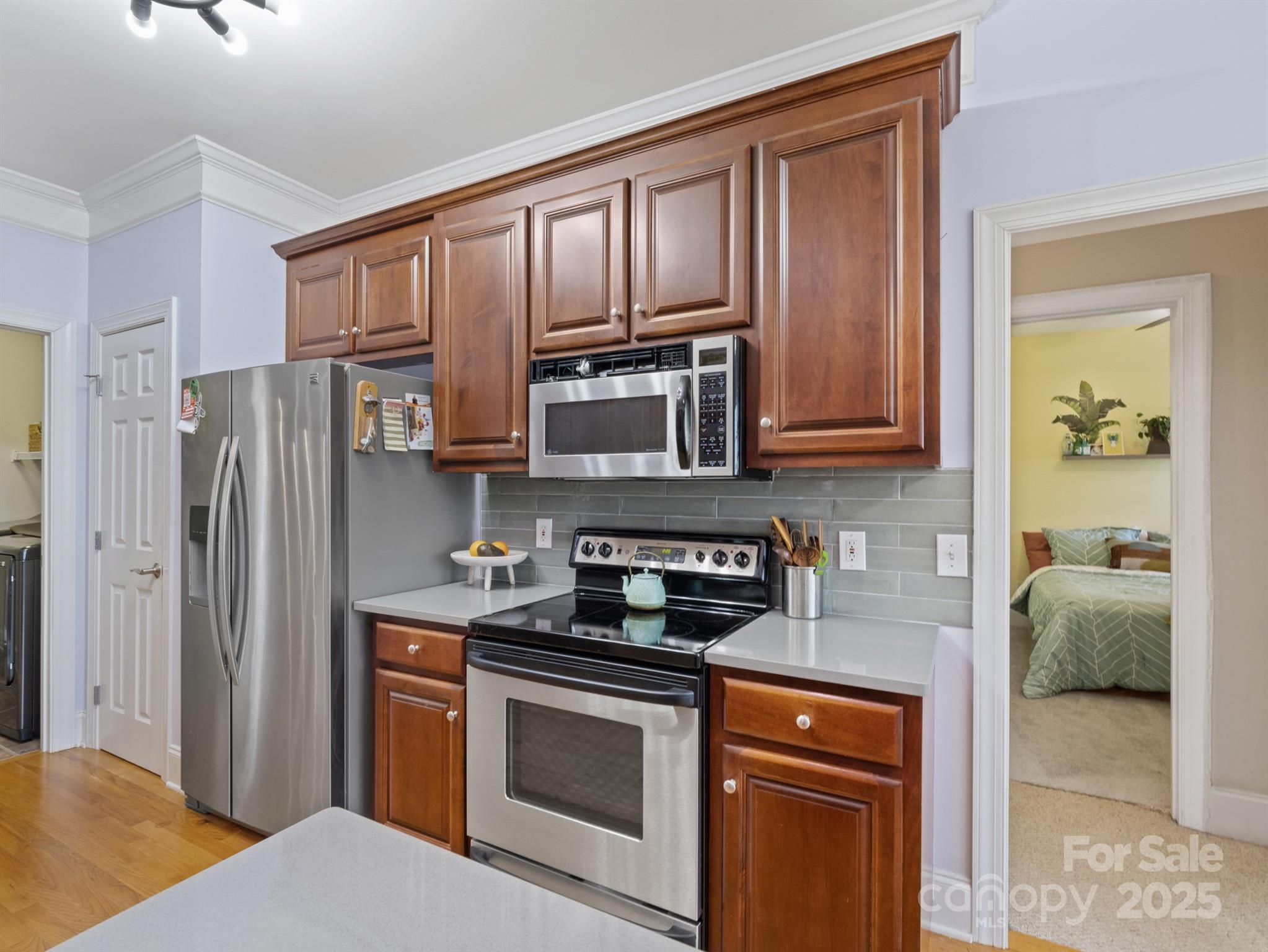 4739 Morris Glen Drive Concord, NC 28027 - Photo 13 of 40 a kitchen with stainless steel appliances granite countertop a stove microwave and refrigerator