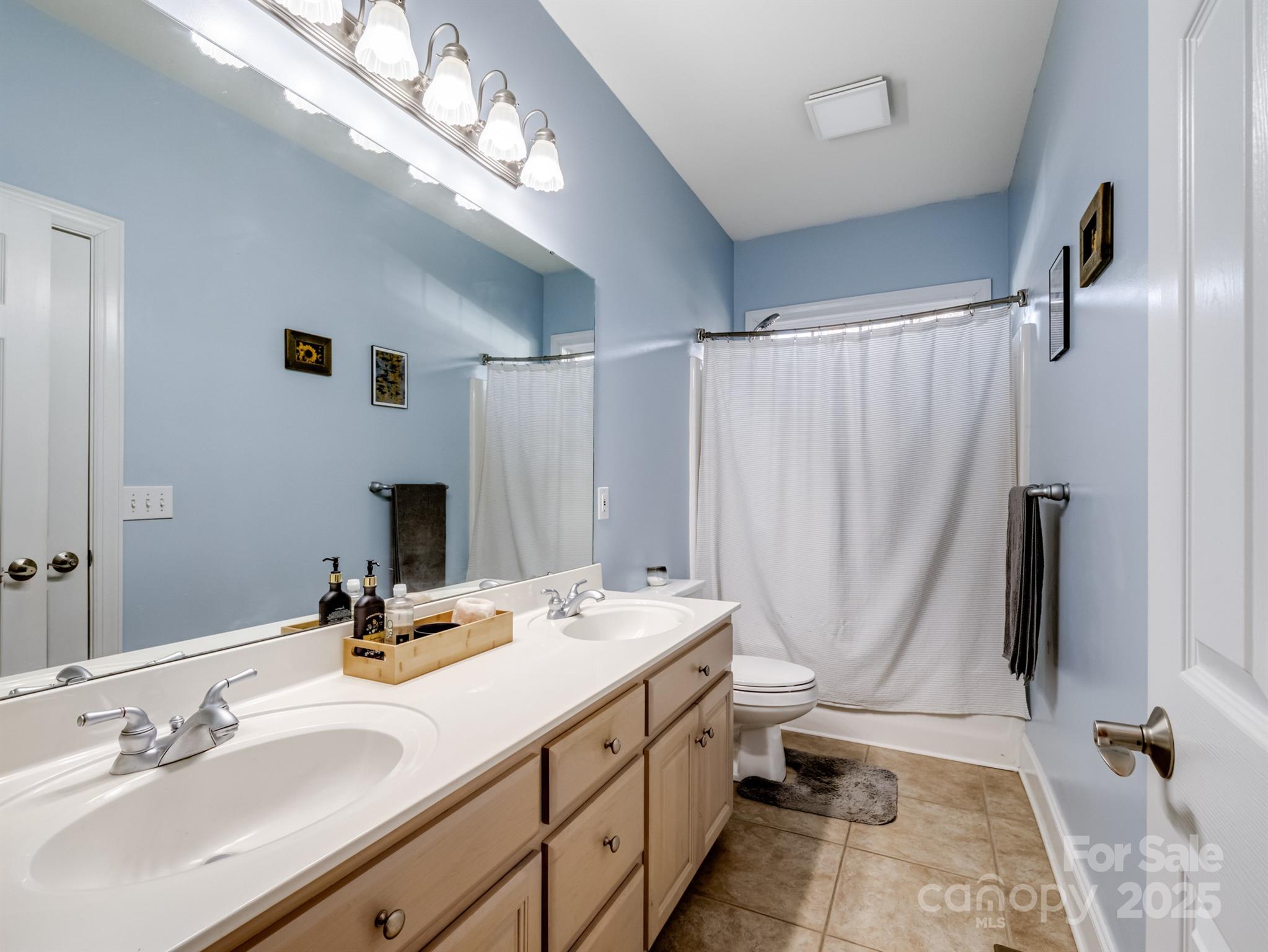 4739 Morris Glen Drive Concord, NC 28027 - Photo 26 of 40 a bathroom with double vanity sink and a mirror
