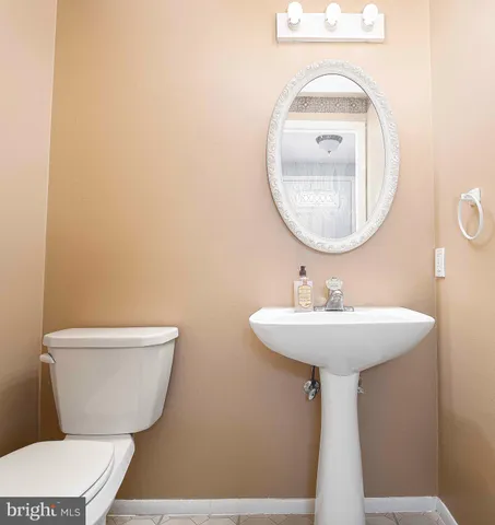 a bathroom with a toilet a sink and a mirror