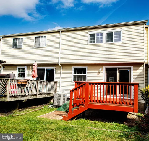 a view of a house with a wooden deck