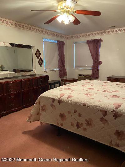 13 B Spring Street Whiting, NJ 08759 - Photo 11 of 14 a bedroom with a bed and a dresser