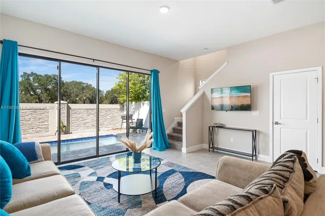 a living room with furniture and a large window