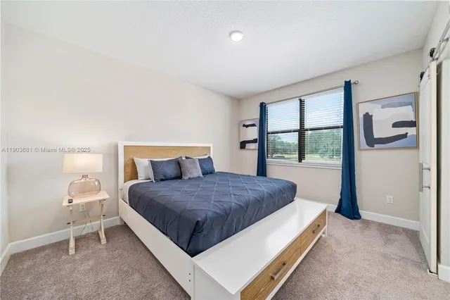 a living room with a bed furniture and a window