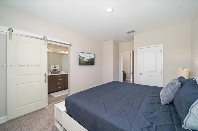 a bedroom with a bed and a dresser