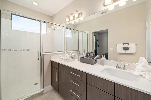 a bathroom with a double vanity sink and a mirror
