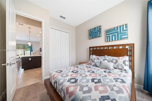 a bedroom with a bed and a view of bathroom