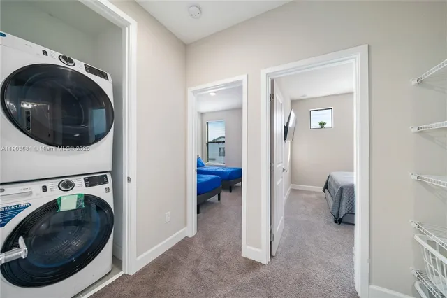 a view of a hallway with washer and dryer