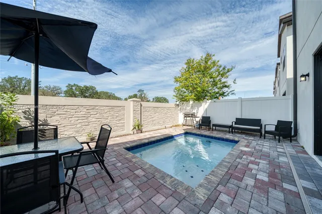 a view of a chairs and table in the patio with a fire pit