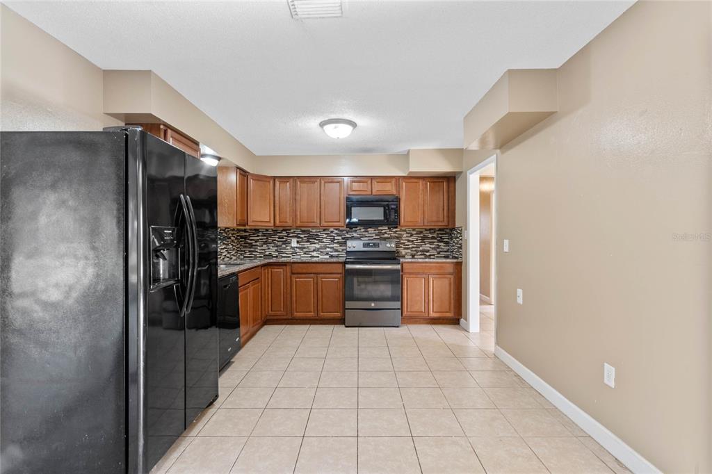 1033 Shore Acres Road Mount Dora, FL 32757 - Photo 9 of 48 Kitchen with granite counters and eat-in space to right