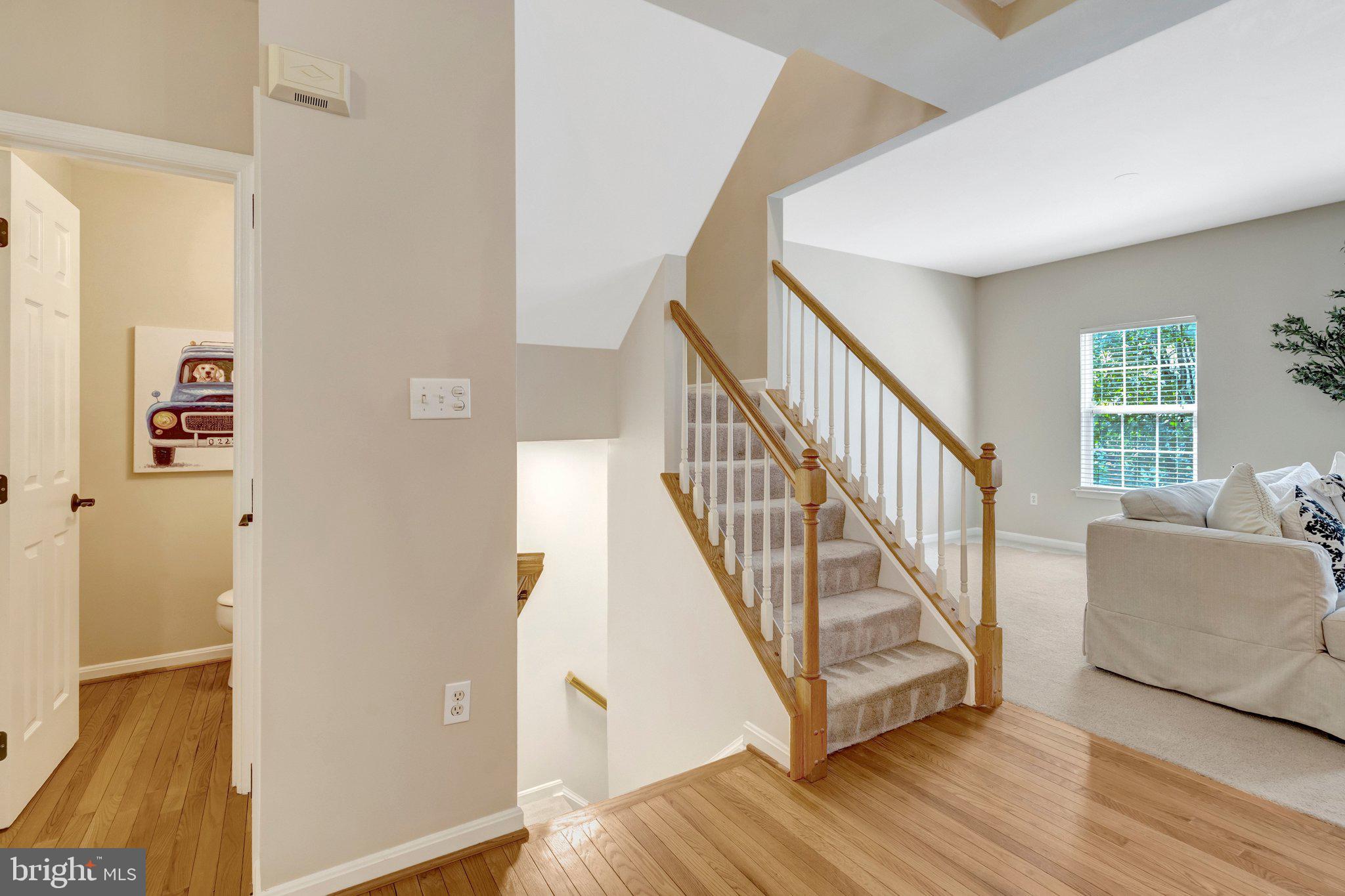 7706 Shadowcreek Terrace Springfield, VA 22153 - Photo 12 of 30 a view of a hallway with wooden floor and staircase