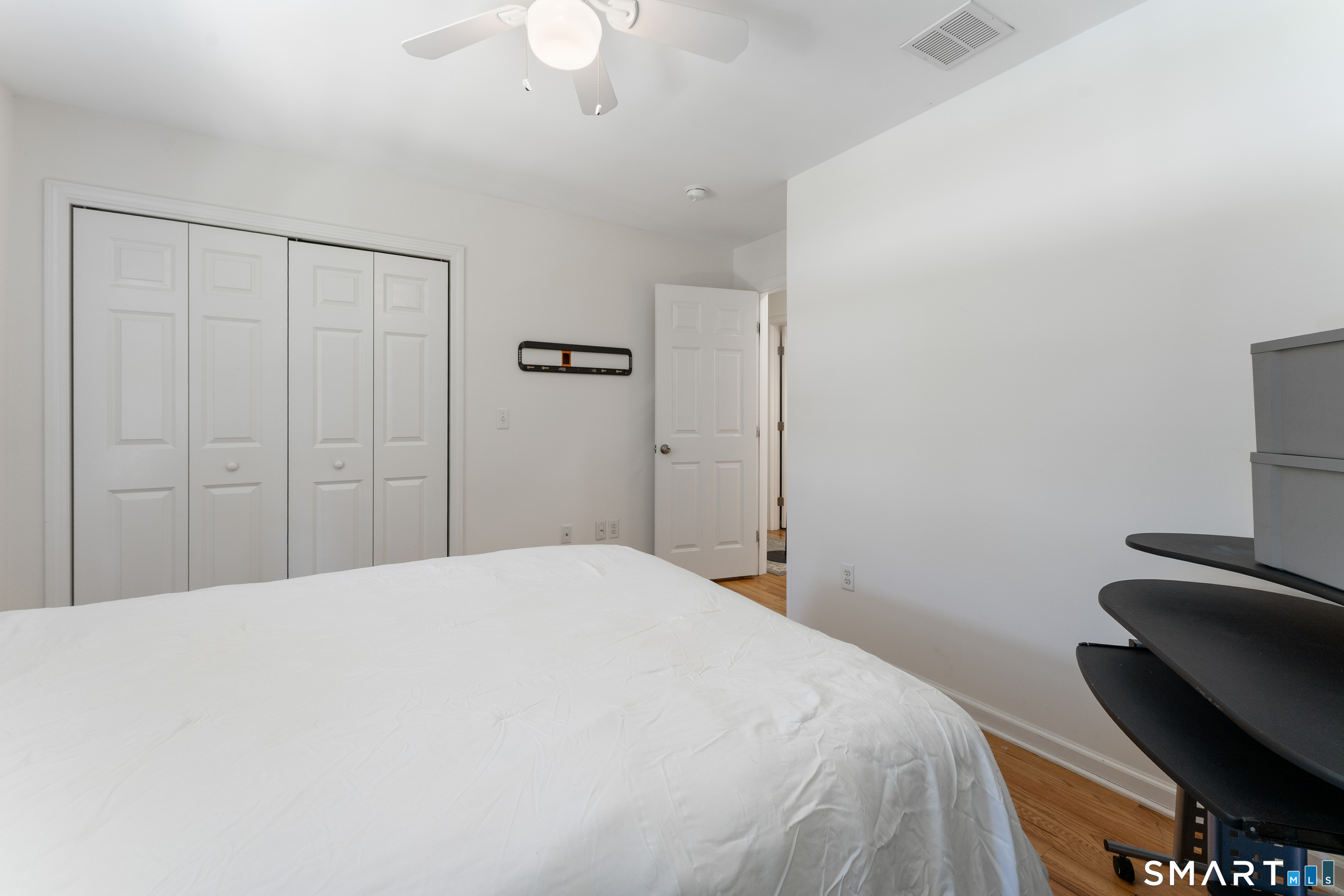 261 Spring Road North Haven, CT 06473 - Photo 37 of 39 a bedroom with a bed and a chandelier