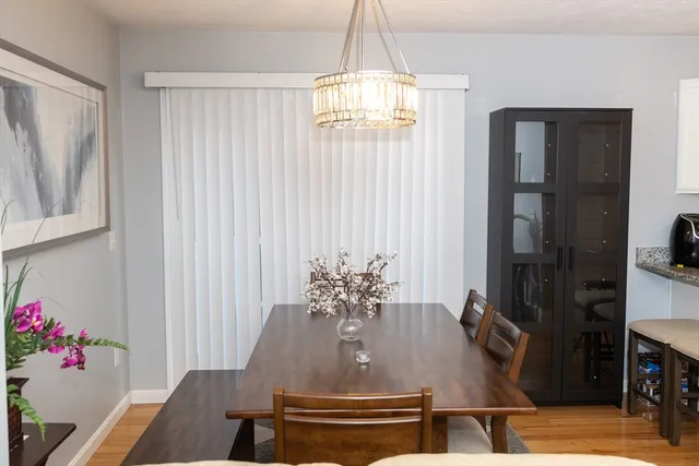 a view of a dining room with furniture and chandelier