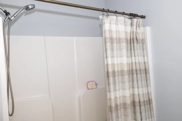 a bathroom with a shower and a tub