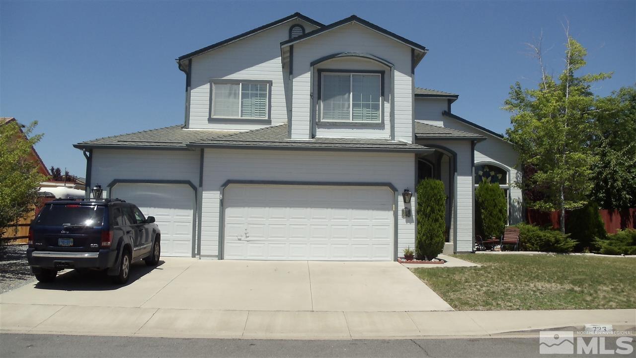 a front view of a house with garage