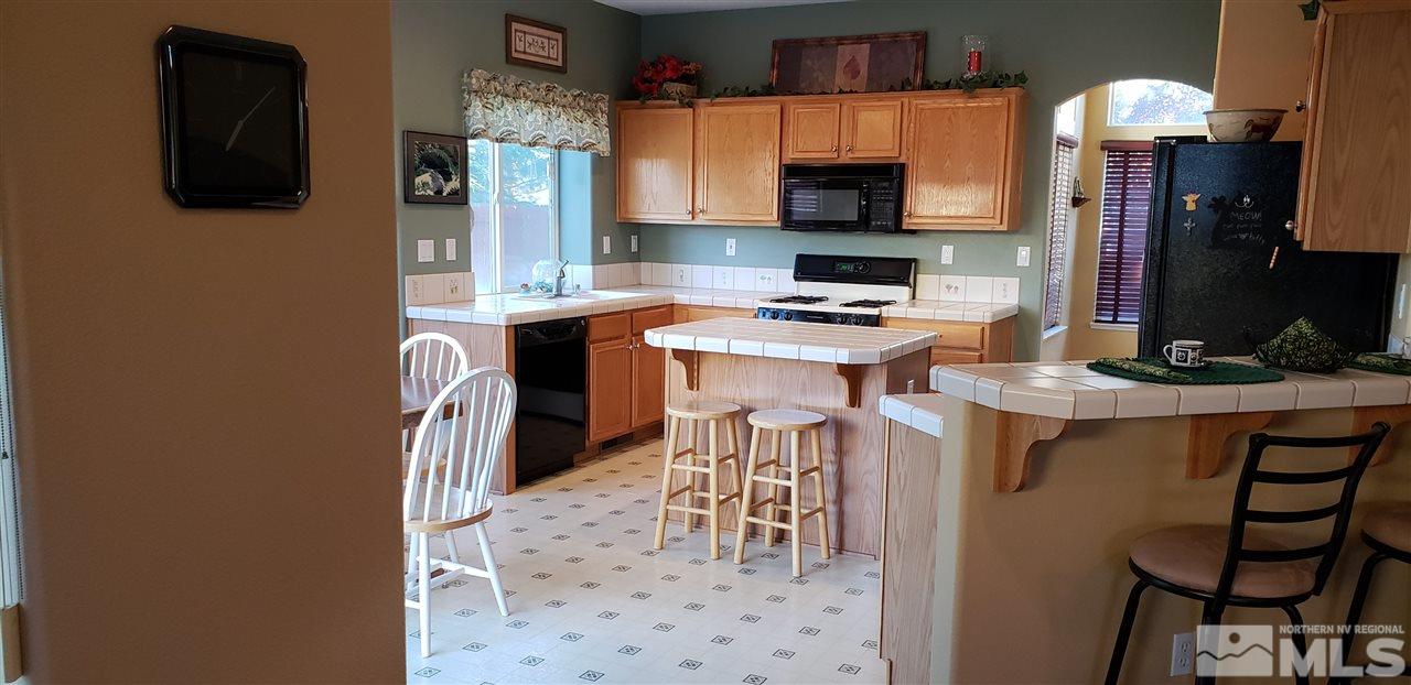 723 Silver Mine Court Reno, NV 89521 - Photo 3 of 17 a kitchen with stainless steel appliances a stove refrigerator sink and microwave