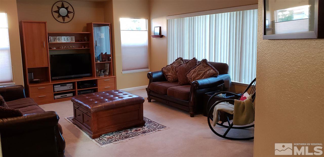 723 Silver Mine Court Reno, NV 89521 - Photo 5 of 17 a living room with furniture a flat screen tv and kitchen view