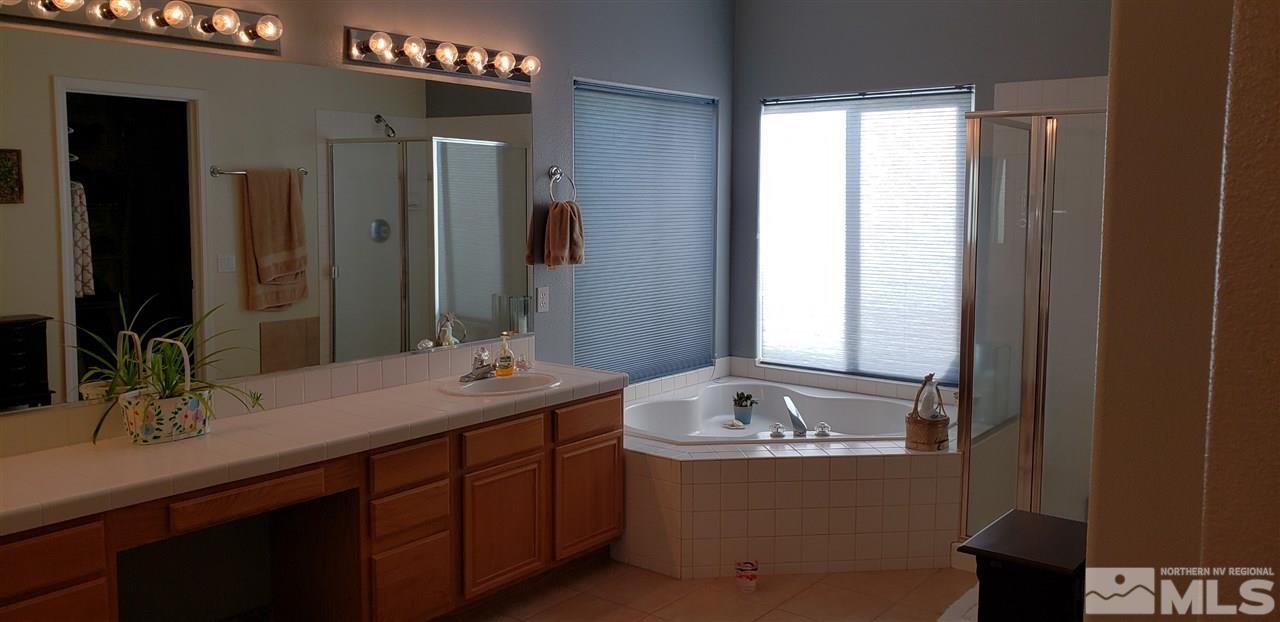 723 Silver Mine Court Reno, NV 89521 - Photo 8 of 17 a bathroom with a tub sink and mirror