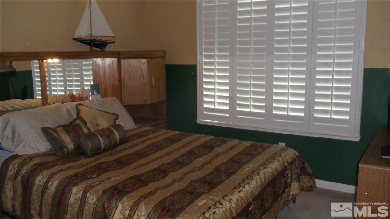 723 Silver Mine Court Reno, NV 89521 - Photo 9 of 17 a bedroom with a bed and a window