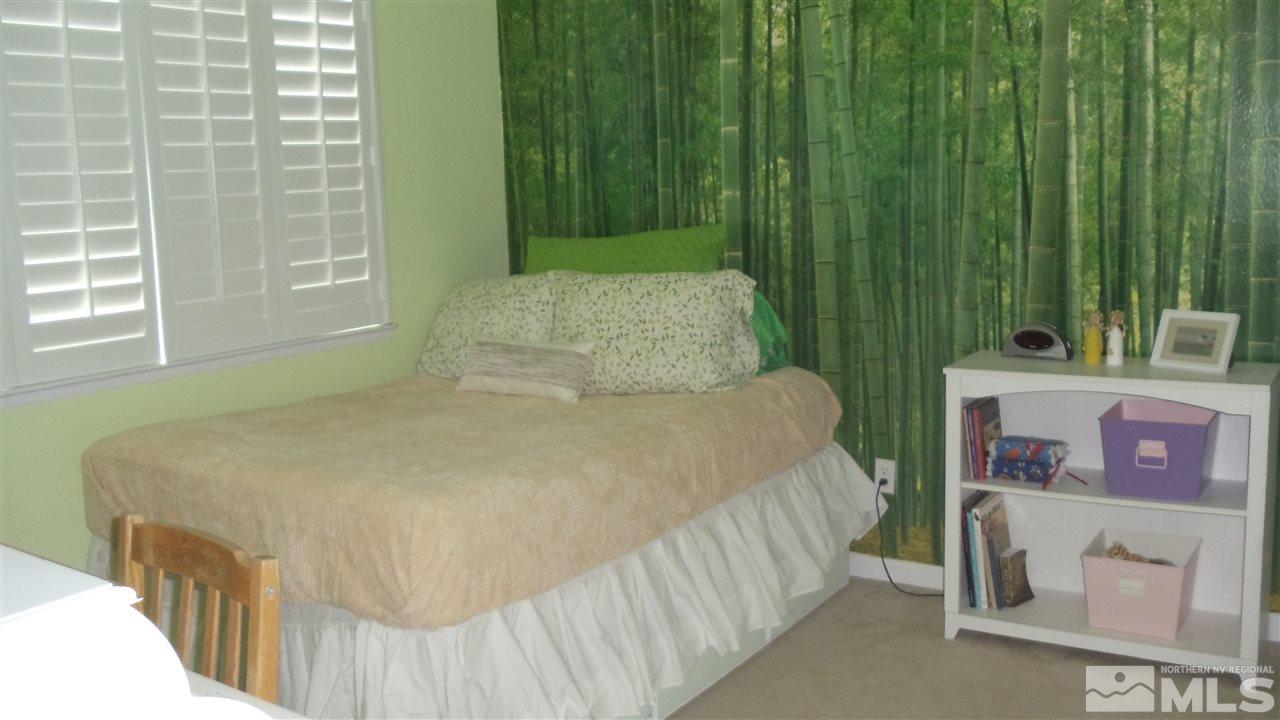 723 Silver Mine Court Reno, NV 89521 - Photo 10 of 17 a bedroom with a bed and a window
