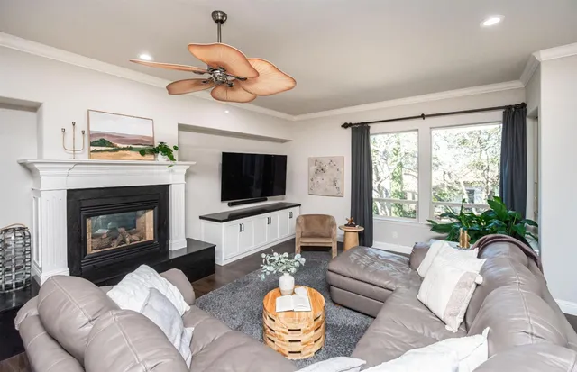 a living room with furniture a flat screen tv and a fireplace