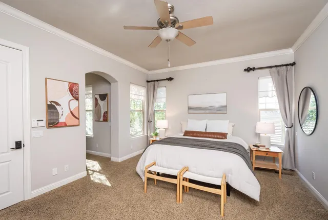 a bathroom with a granite countertop double vanity sink a mirror and a bathtub