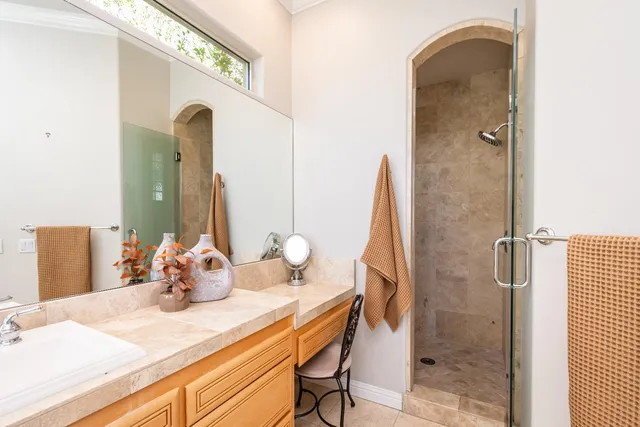 a living room with furniture a flat screen tv and a large window