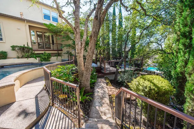 a view of a house with a small yard and wooden fence