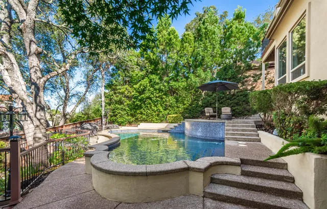 a view of patio with table and chairs and potted plants